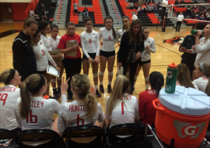 Coach Karen Naymola talks to her team during a time-out in the regional final (E. Kubelka).