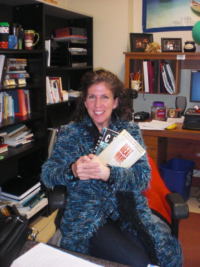 Kathy Meyer holds textbooks for next years new classes (M. Wilson).