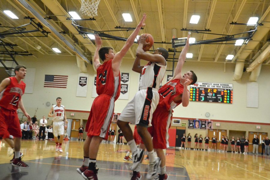 Junior Bryce Only attempts to shoot against two Barrington team players during the senior night game (M. Krebs).