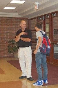 Dan Farlik talks to a student in front of Door 1 (J. Chalas)