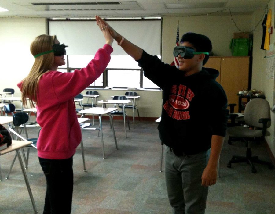 Psychology Club members Shannon Sutkus and Jason Trovella high-five while wearing inversion goggles (H. Baldacci).