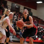 Senior Haley Ream fights to make a lay-up. By Mike Krebs/The Voice