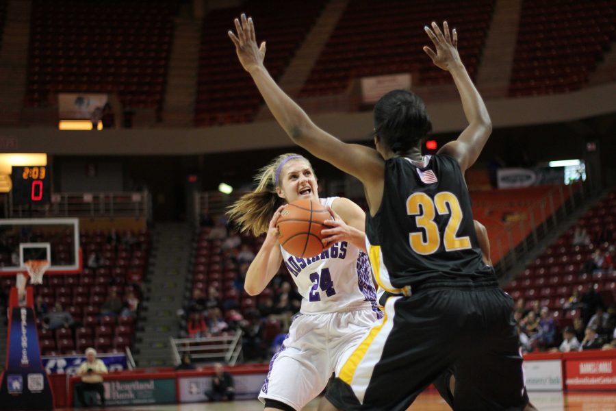 Rolling Meadows Alexis Glasgow struggles to pass Marians defense.