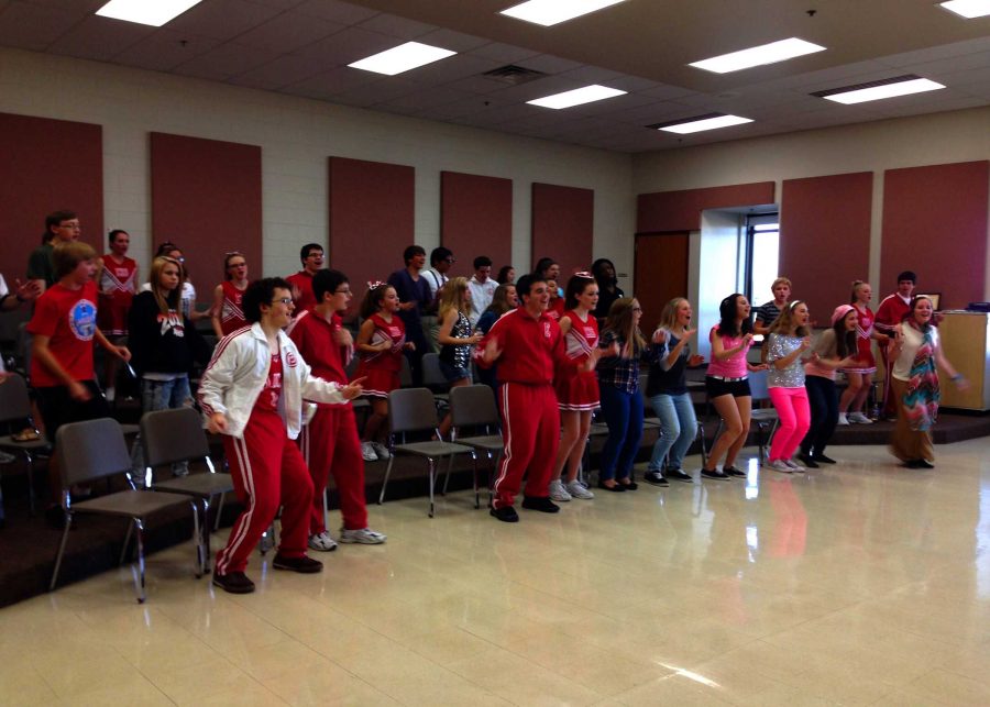 The cast warms up in the choir room before taking the stage at their Sunday performance.