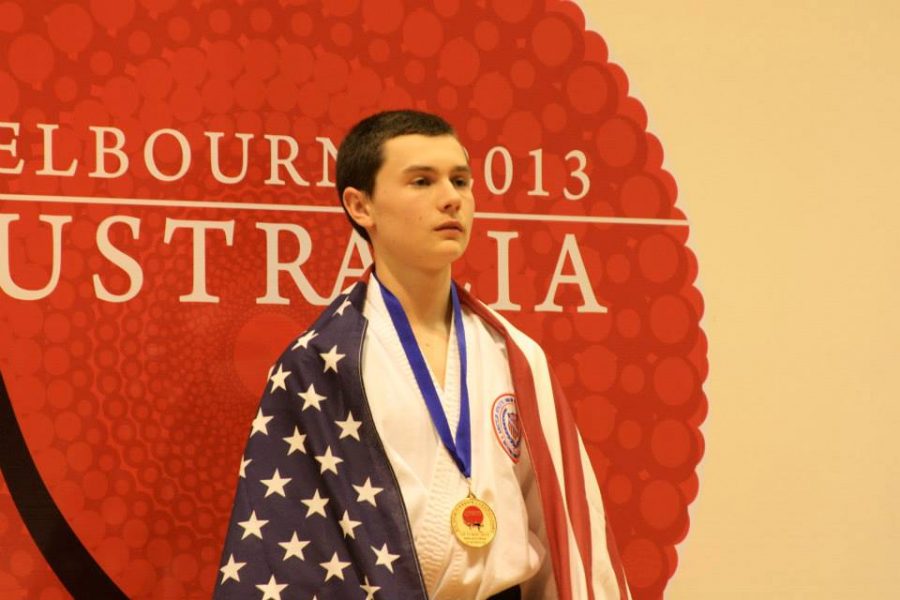 Allare stands with his gold medal (photo courtesy of J. Allare).