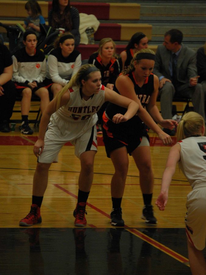 Sophomore Ali Andrews boxes out a Central player before going for a rebound.