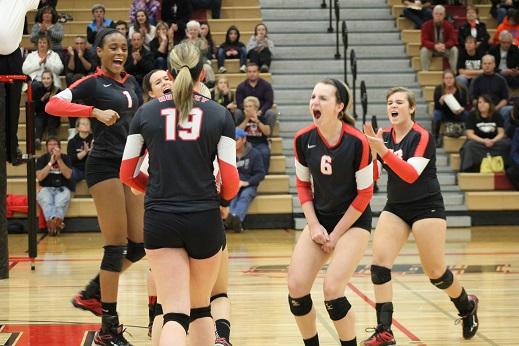 Volleyball players Sydney Holt, Kelsey DeWulf, Ally Dion, and Lexi Smith celebrate a kill made by Erin Erb during the regional game against Jacobs.