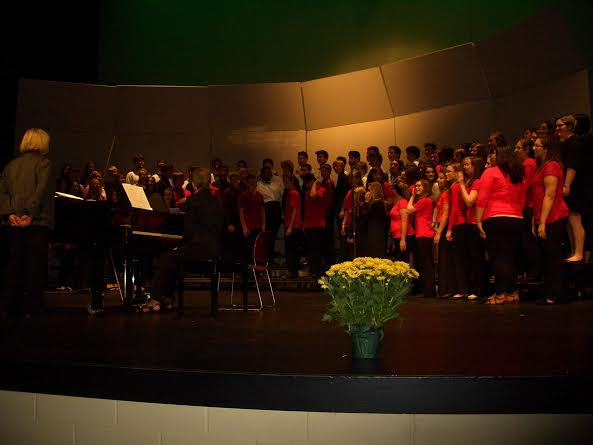 The freshman mixed choir perform on the stage (Brands).