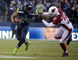 Seattle Seahawks running back Marshawn Lynch, left, stiff arms Cardinals cornerback Patrick Peterson in the fourth quarter at CenturyLink Field in Seattle, Sunday, Dec. 22, 2013. The Cardinals beat the Seahawks, 17-10. (Joe Barrentine/Tacoma News Tribune/MCT)