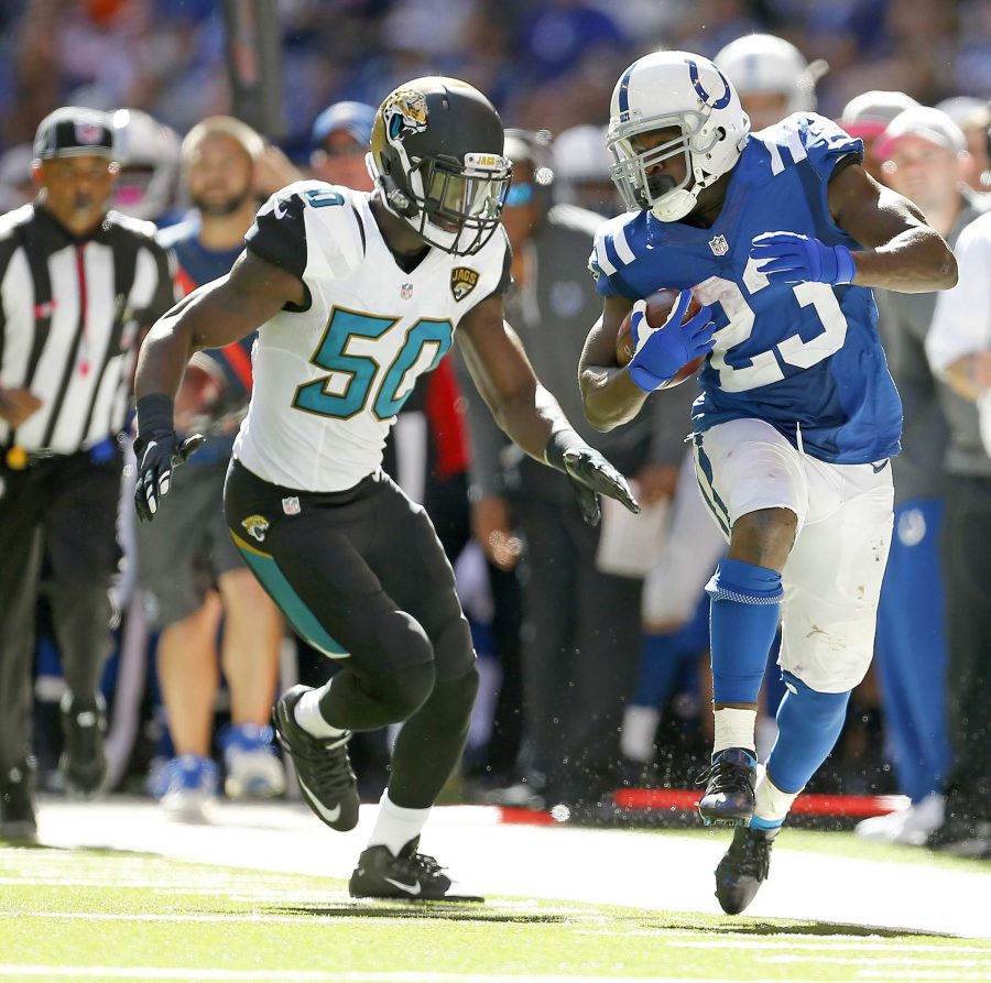 Indianapolis Colts running back Frank Gore (23) runs down the sidelines against Jacksonville Jaguars outside linebacker Telvin Smith (50) during second half action on Sunday, Oct. 4, 2015, at Lucas Oil Stadium in Indianapolis. (Sam Riche/TNS)