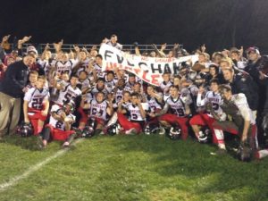The Huntley Red Raiders celebrate after defeating the Dundee-Crown Chargers 46-3, completing the first undefeated season in school history. (Courtesy of Alex Kantecki, Northwest Herald.)