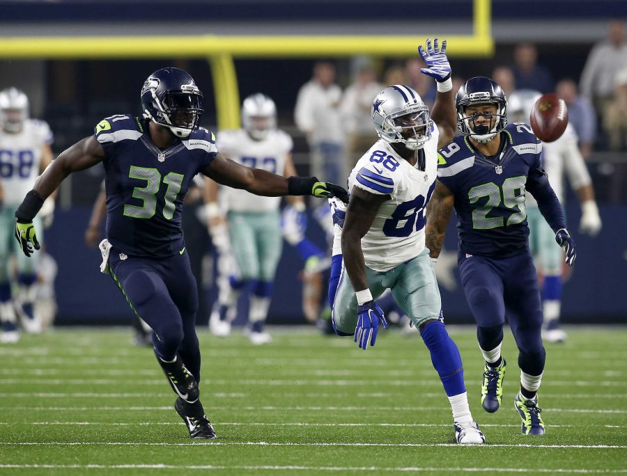 Dallas Cowboys wide receiver Dez Bryant (88) can't reach a deep ball as Seattle Seahawks strong safety Kam Chancellor (31) and Seattle Seahawks' Earl Thomas (29) defend late in the second half on Sunday, Nov. 1, 2015, at AT&amp;T Stadium in Arlington, Texas. (Brad Loper/Fort Worth Star-Telegram/TNS)