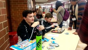 Senior Christian Olivera sells two packages of fruit snacks for a dollar. 