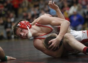 Huntley's Gannon Kosowski, top, tries to pin Justin Peters of Jacobs on Jan 14. The Red Raiders fell to the Golden Eagles 32-28. (courtesy of M. Apgar, Northwest Herald)