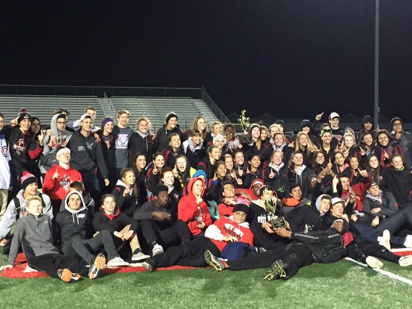 The boys and girls track teams pose with their McHenry County trophies (Courtesy of Huntley Athletics).