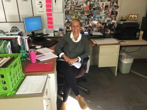 English teacher Rochelle Hewlett poses at her desk for a photo. 