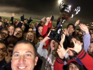 Principal Scott Rowe takes a selfie while students hold up the trophy (S. Rowe)
