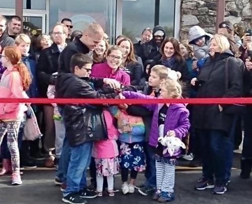 Mary Holzkopf with her family and community on grand opening day. 