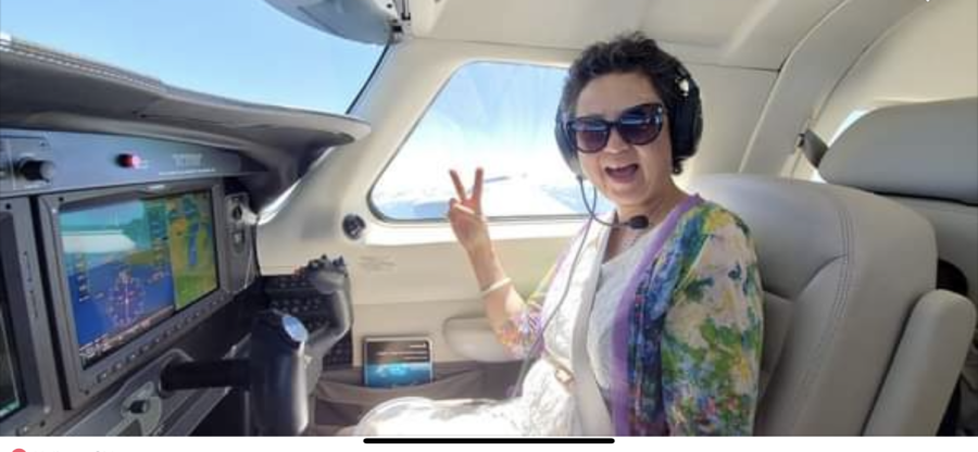 Shi pictured playfully in the front of an aircraft.