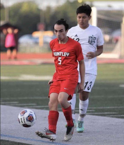 Senior Drew Tafur dribbles the ball past his opponent. (Courtesy of D. Tafur)