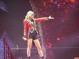 Swift performing at her original Red tour in March, 2013, singing We Are Never Getting Back Together in the classic outfit.