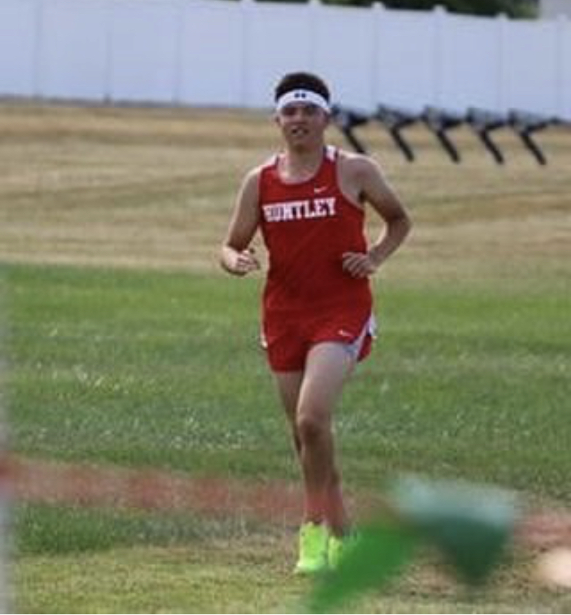 Taylor runs in a Huntley cross country meet
