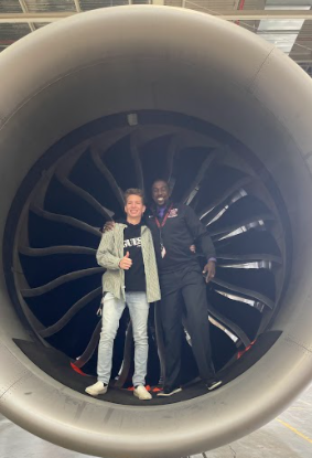 Andrew Cantrell and Marcus Belin standing in the engine of a 787 airliner.