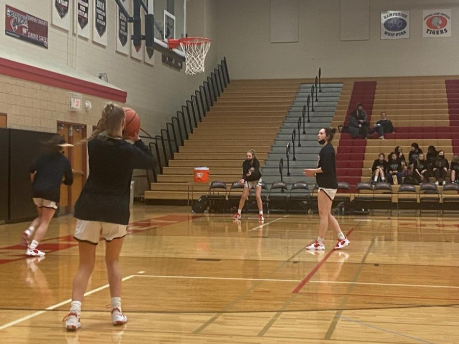 Huntley practices their three-pointers during pre-game warm ups.