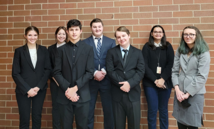 The Mock Trial team, dressed up in uniform suits, to compete.