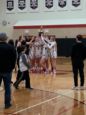 Girls basketball holds the Fox Valley Conference trophy.