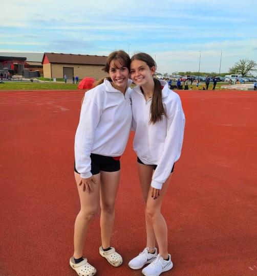 Tenuto and another member of the team, Annie Mitchell, stand together on the track.