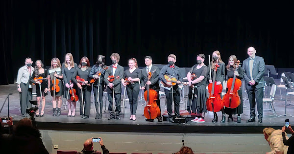 The Huntley High School seniors at their last concert with directors Leah Novak and Jeff Rollins.