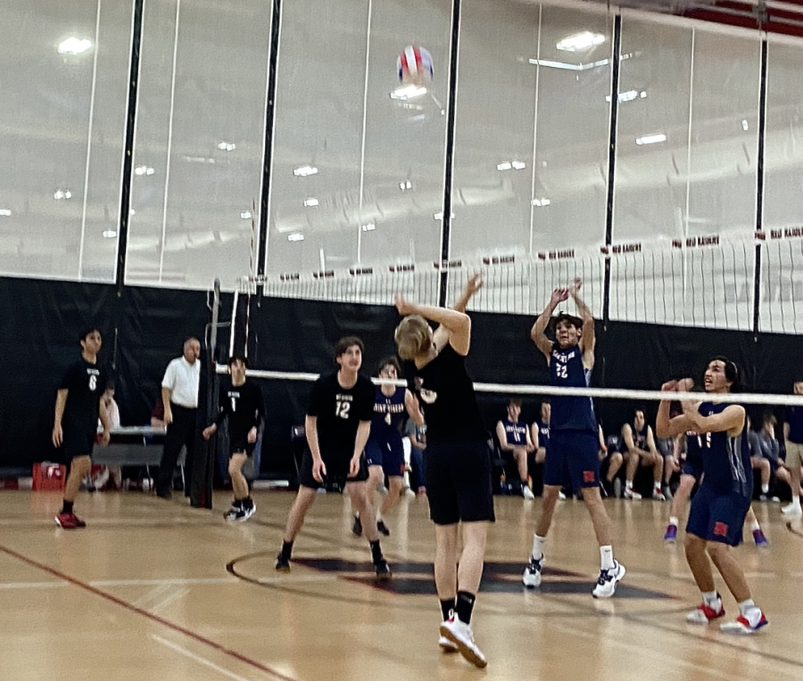 Varsity+team+member+Daniel+Baginski+prepares+to+spike+the+ball+over+the+net.