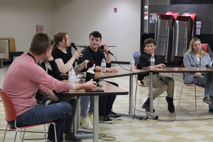 Students sit at a panel at the Recognizing American Diversity LGBTQ+ event. 