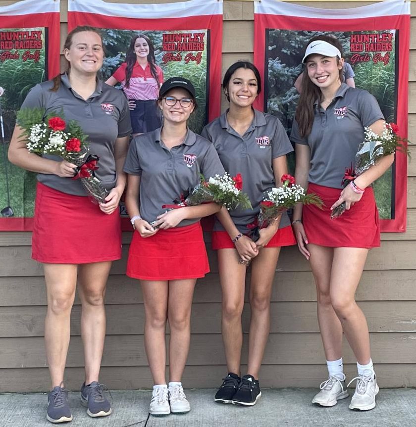 Seniors Mallory Winters, Abigail Panier, Brianna Ferrara, and Samantha Campanelli standing with their bouquets of flowers. 
