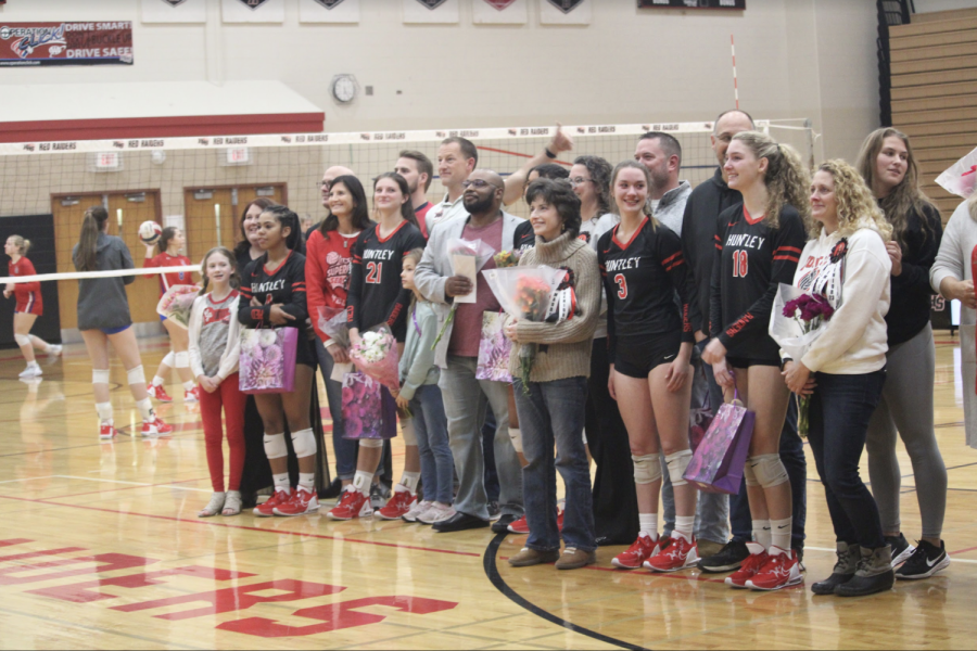 (D. Doyle) Seniors on the Volleyball team with their families getting ready for a picture.