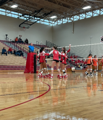 The team gathers together after winning a point.