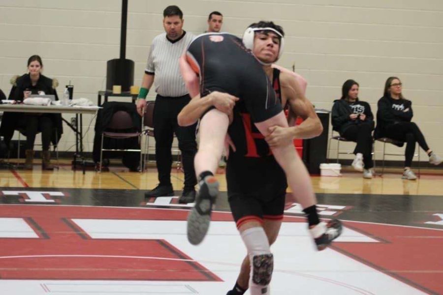 Adam Pena in the middle of a wrestling match.