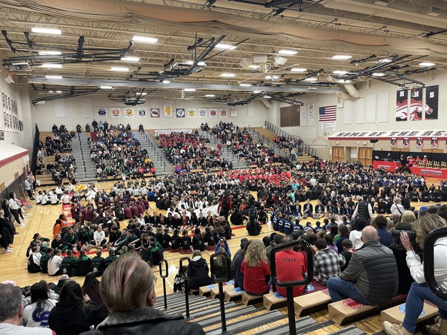 As the judges decide on the winners, each dance team gathers in the middle and holds hands for good luck.