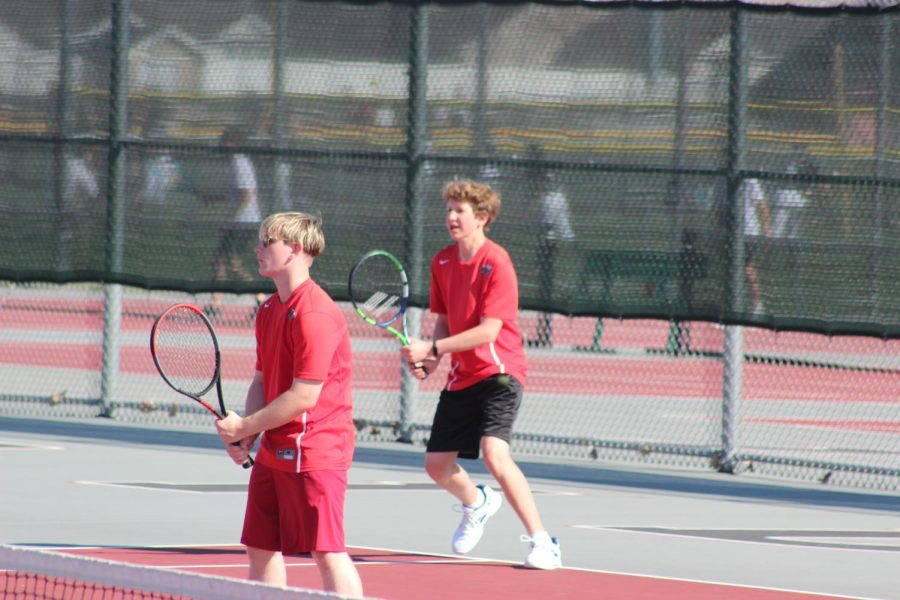 In doubles tennis both huntley players getting ready for the serve.