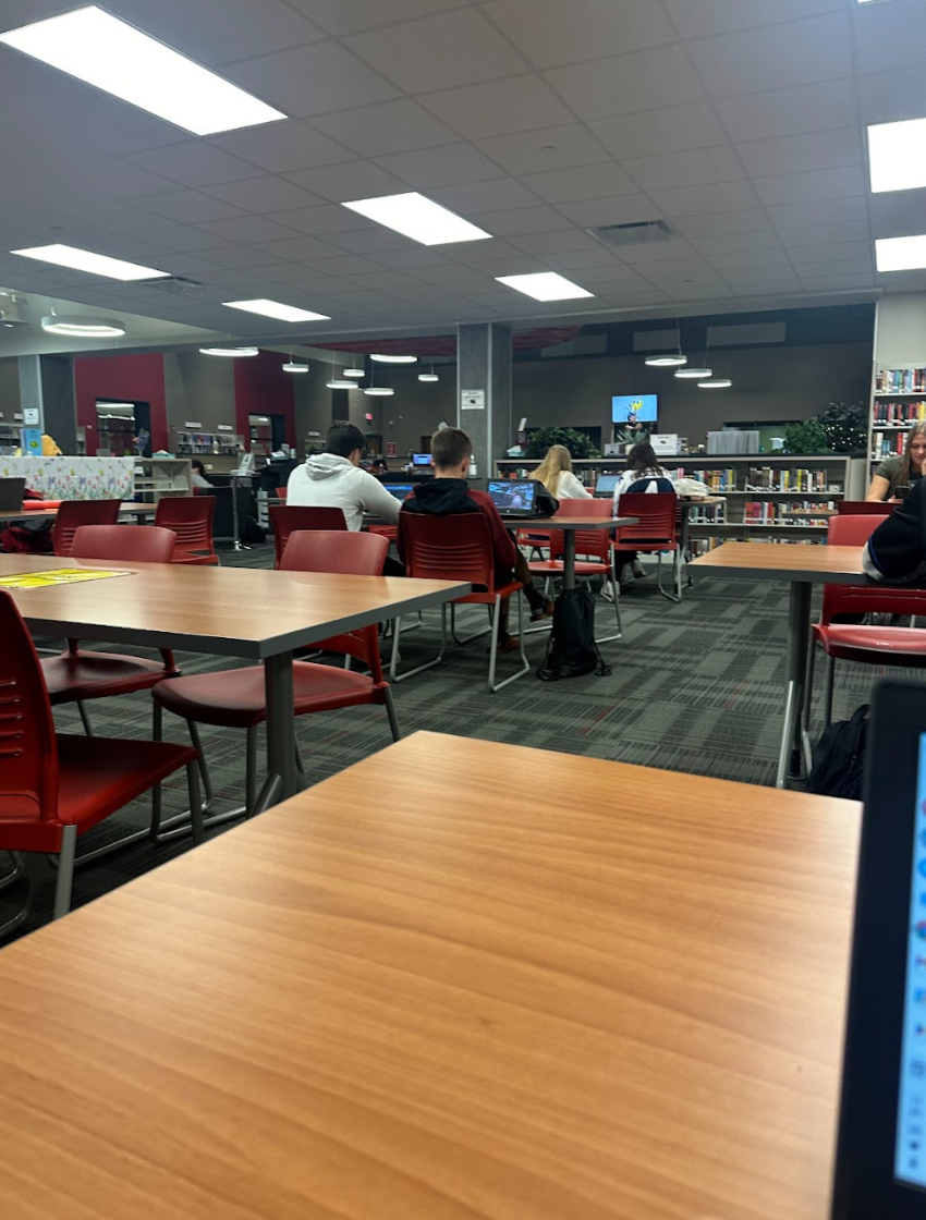 Students in the HUB are actively working on assignments and homework for various classes.