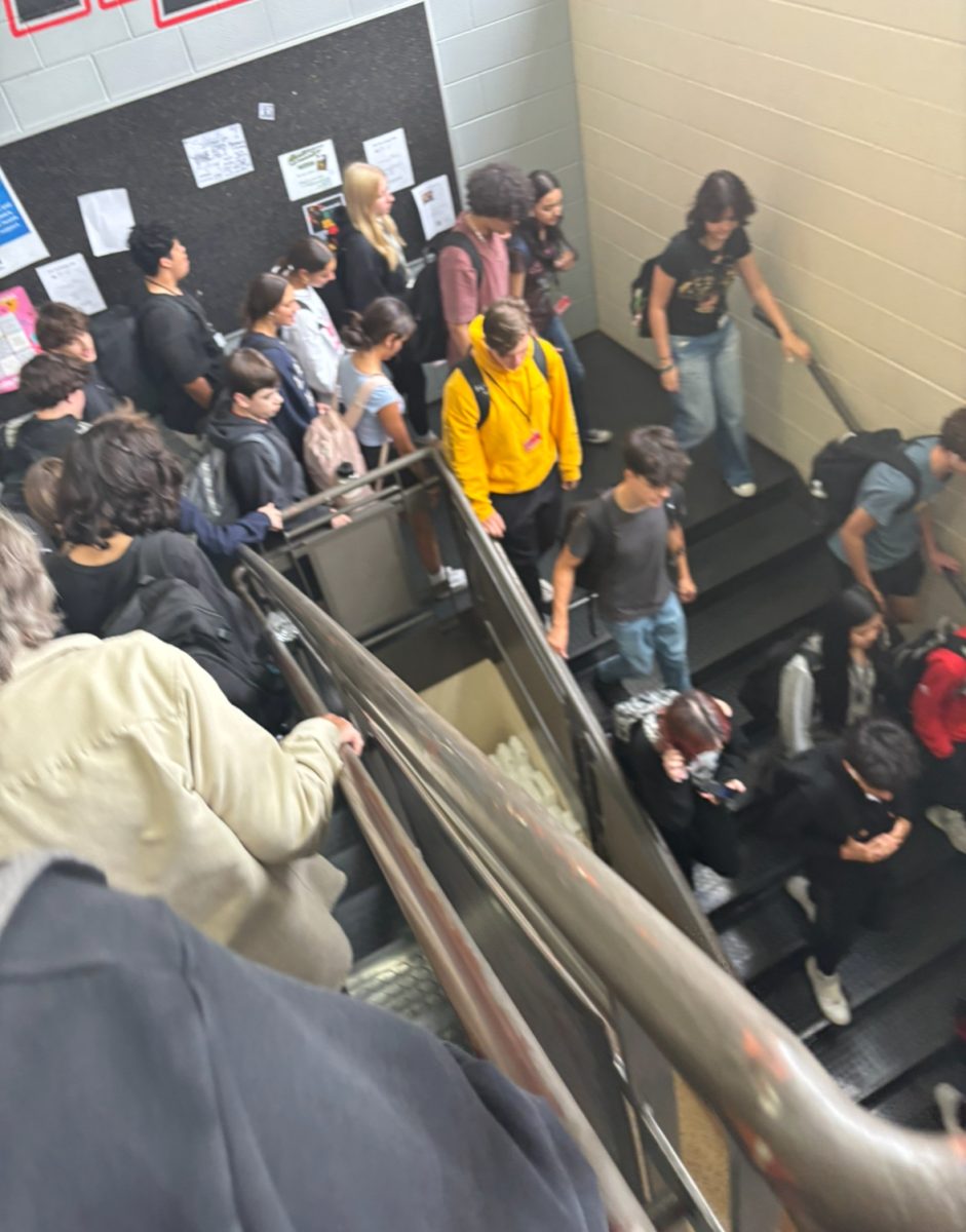 Crowded staircase after school as students rush to their cars. 