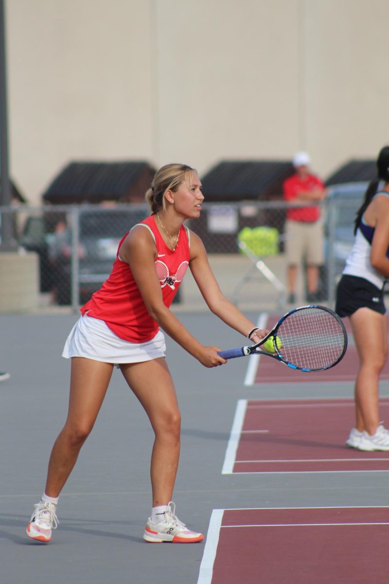 Junior Julie Klockner getting ready to serve during a doubles match.