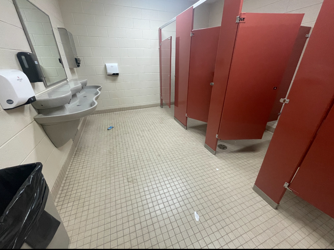 HHS upstairs bathroom with trash on the floor.