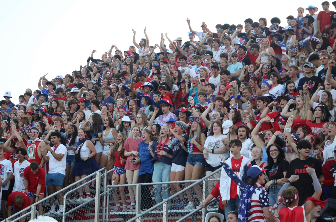 Students stay active in raising school spirit during the USA football game while others tag along for the ride.