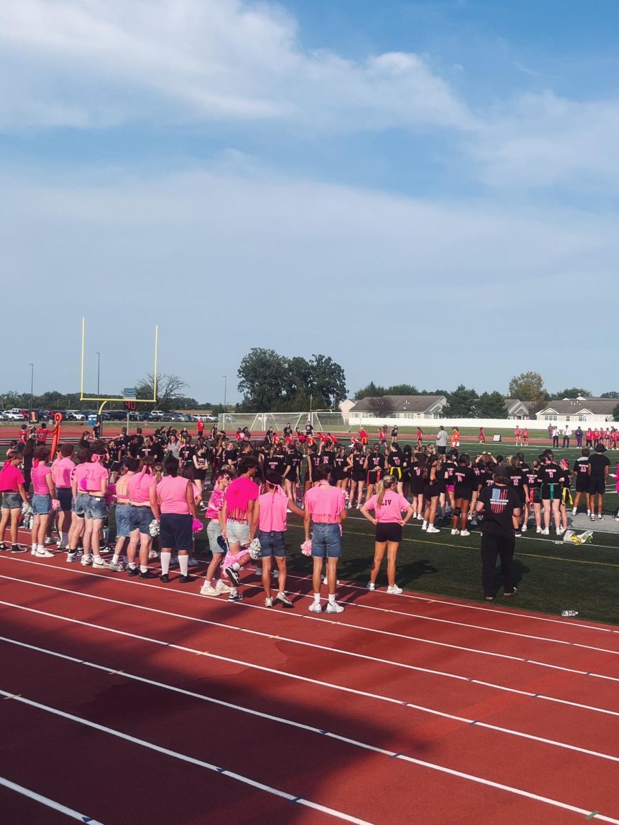 Guys poms stands in front of the field preparing for their annual performance.