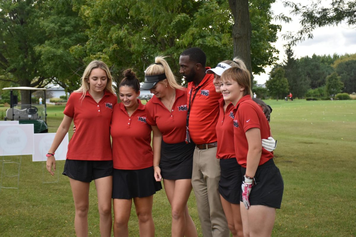 Principal Marcus Belin taking pictures with seniors Gianna Pristera, Shaeyna Chez, Maddie Sloan, Annie Garrard, and Taryn Rainey (left to right).