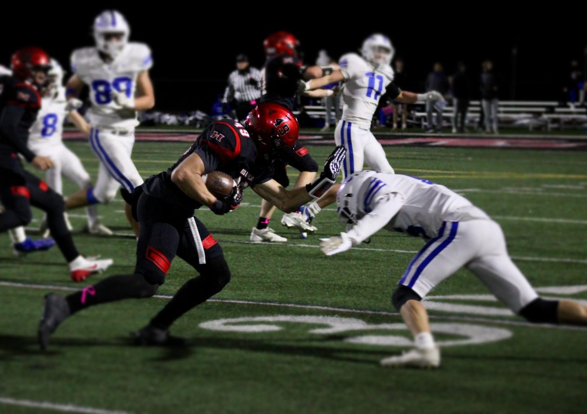 As Ari Fiebig catches the ball. he starts running trying to tackle the other player down. 