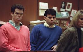 The Menendez Brothers stand together, eyebrows closely knit together in focus. 