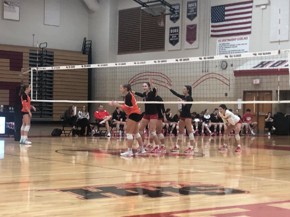 Huntley's girls volleyball team prepares for the next serve.